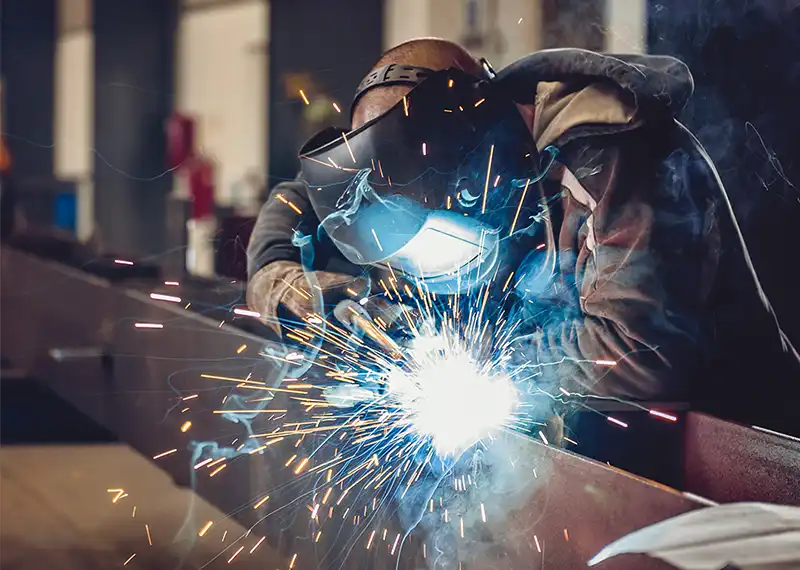 Arbeiter beim Schweißen mit Lichtbogenschweißgerät